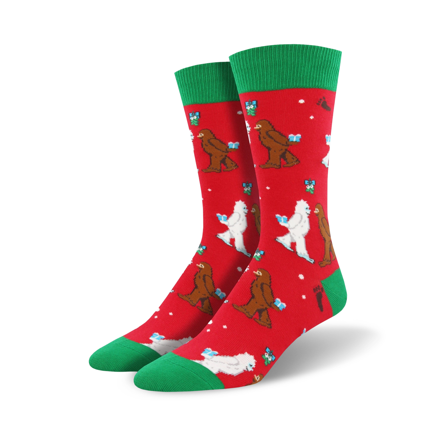 Crew socks in red with green cuffs.  The design features Bigfoot and Yeti figures exchanging gifts in a playful Christmas scene.