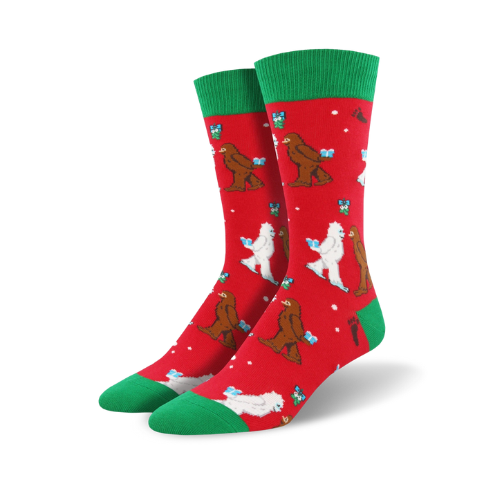 crew length christmas socks in red with cartoonish white abominable snowmen wearing santa hats and carrying gifts on a red background with green snowflakes and a green top.    }}