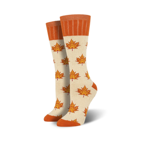 off-white boot socks featuring a maple leaf pattern in orange with an orange cuff at the top. perfect for women who love the outdoors.  