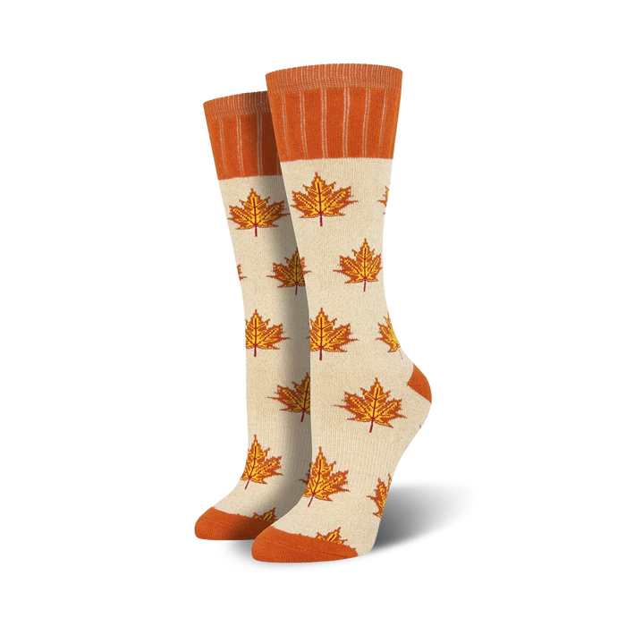 off-white boot socks featuring a maple leaf pattern in orange with an orange cuff at the top. perfect for women who love the outdoors.   }}