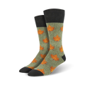Pair of crew socks in olive green with orange maple leaf pattern and dark gray cuffs. Autumn-themed design.