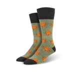 Pair of crew socks in olive green with orange maple leaf pattern and dark gray cuffs. Autumn-themed design.