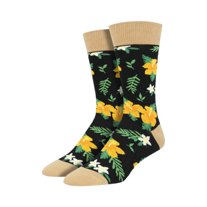 Pair of black crew socks with a bold yellow hibiscus and white flower pattern, tan cuff.