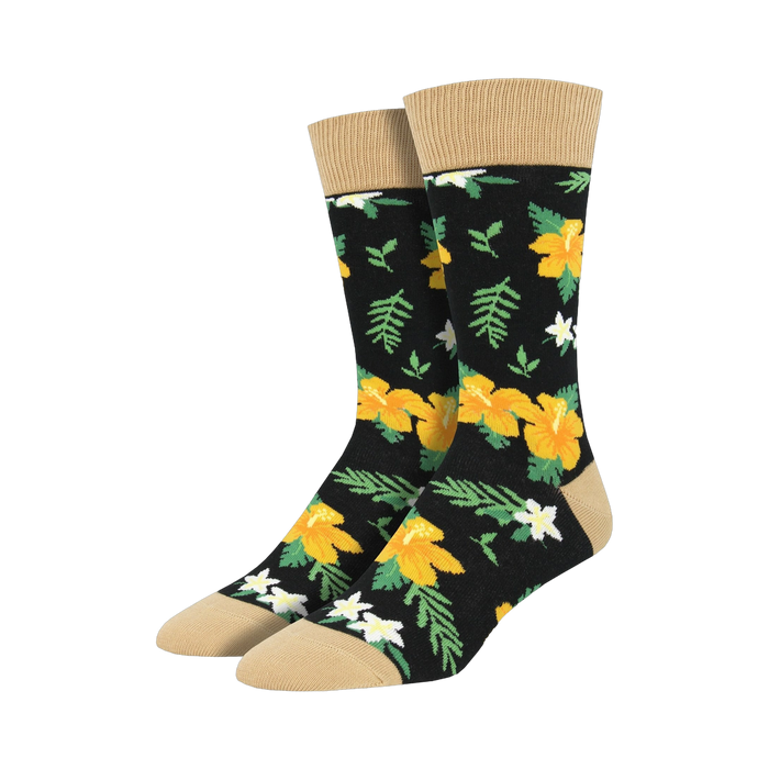 Pair of black crew socks with a bold yellow hibiscus and white flower pattern, tan cuff.