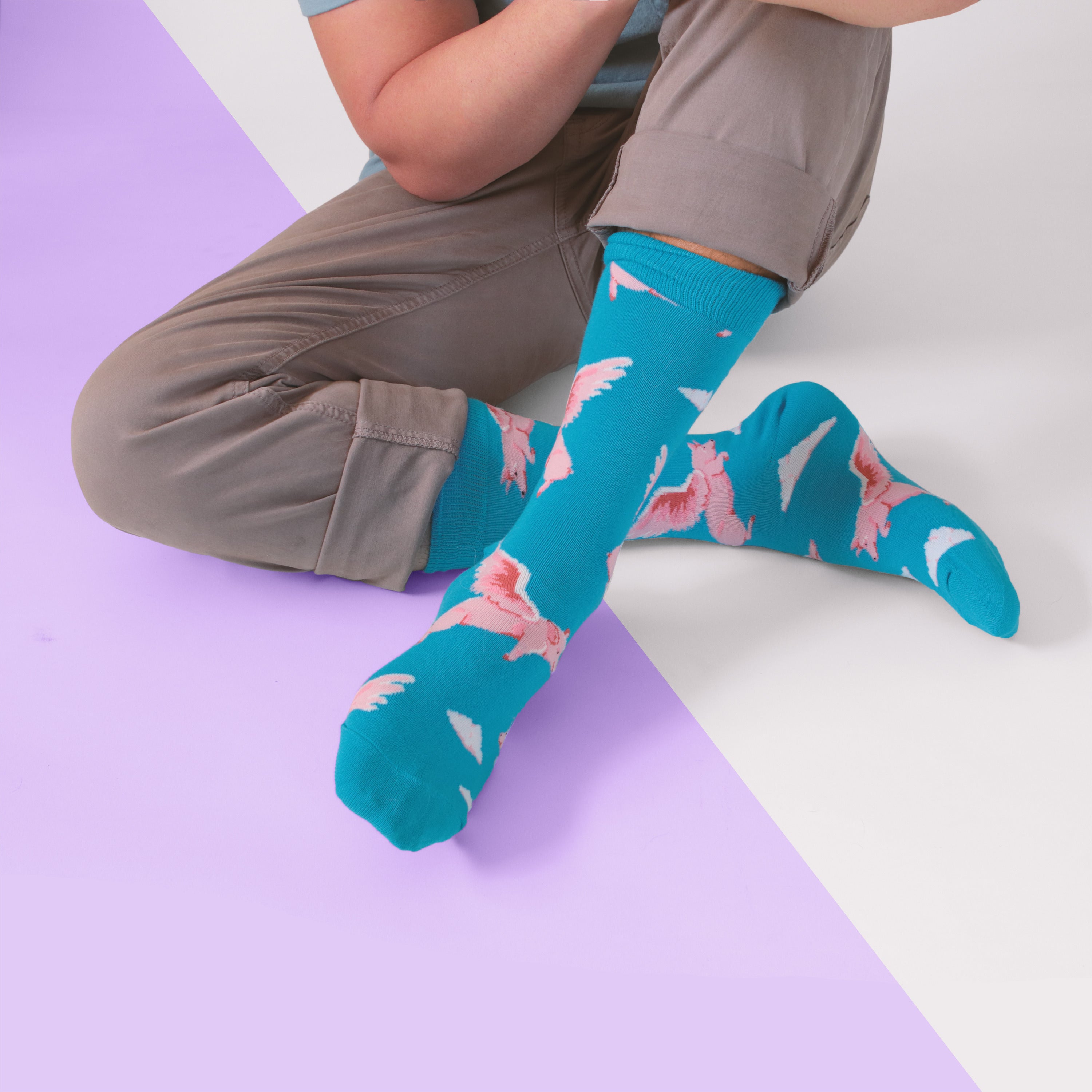Lifestyle shot: Person wearing the Flying Pig socks, showcasing how they look when worn with casual pants. [lf]