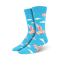 Pair of blue crew socks featuring a fun pattern of pink winged pigs flying above white clouds.