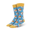 A pair of blue crew socks with a repeating pattern of brown and white bulldog faces. The socks have a mustard yellow cuff.