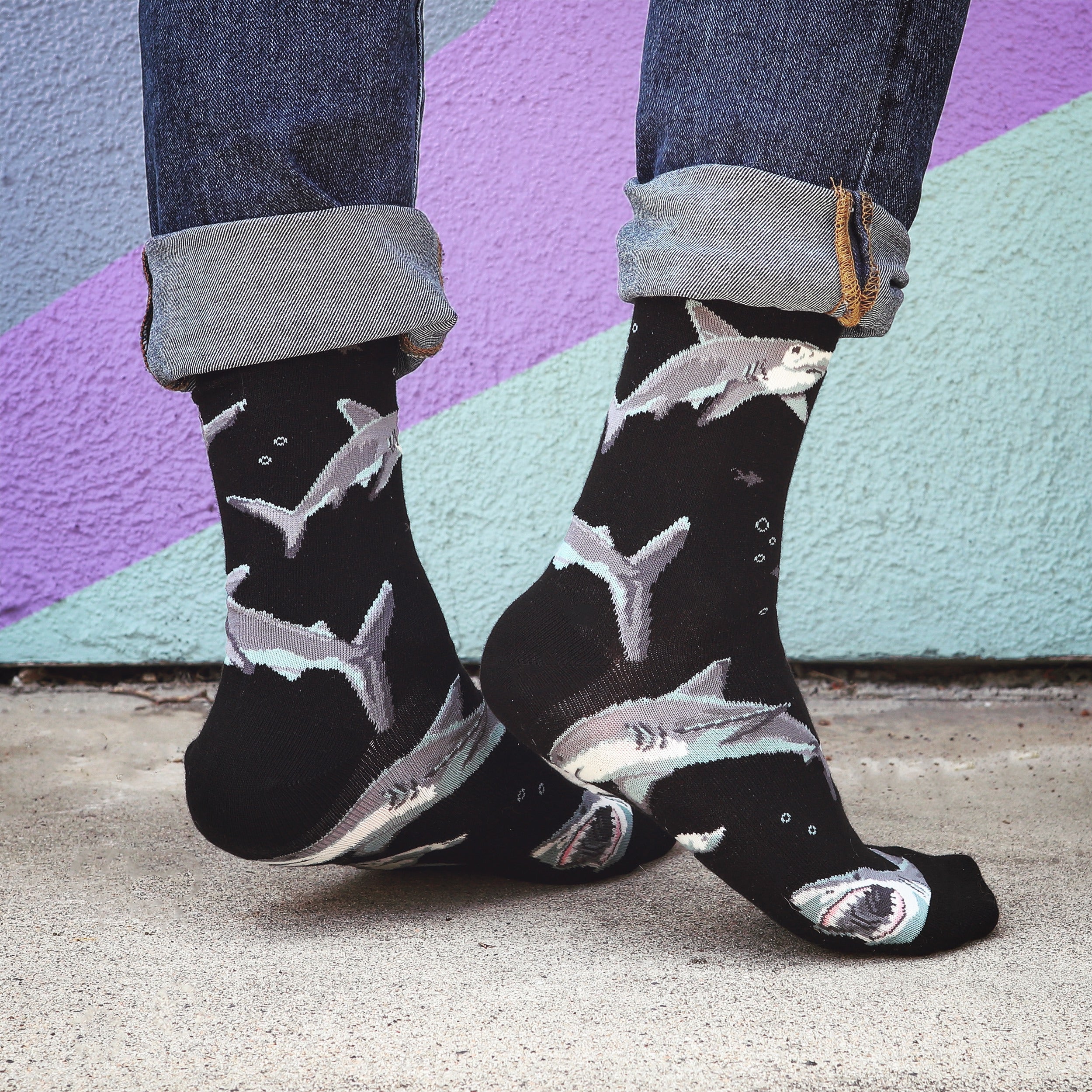 Flat lay product shot showing both black and blue Shark Chum socks side by side. [lf]