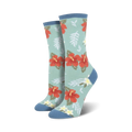 Close-up showing the detail of the red hibiscus flower and green leaf design on a teal crew sock.