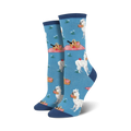 Pair of women's crew socks in blue and green; features white alpacas enjoying picnics with red picnic baskets and apples.