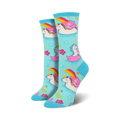 Crew socks in light blue featuring unicorns, Care Bears, and rainbows on inflatable swans. Pink, white, and rainbow accents on a pastel background.