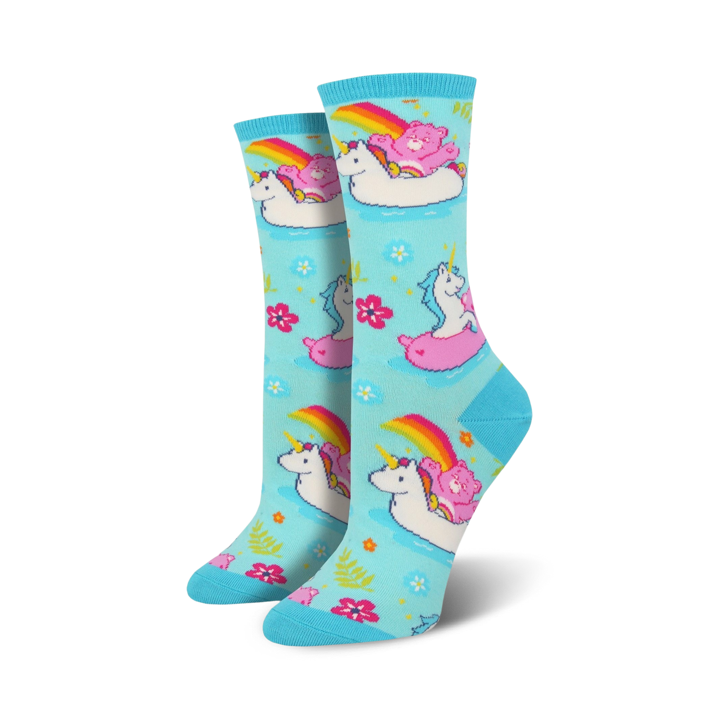 Crew socks in light blue featuring unicorns, Care Bears, and rainbows on inflatable swans. Pink, white, and rainbow accents on a pastel background.