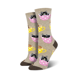 light brown and pink women's crew socks featuring a repeat pattern of tea cups with black and white cats inside.  