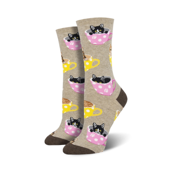 light brown and pink women's crew socks featuring a repeat pattern of tea cups with black and white cats inside.  