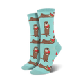 A pair of women's crew socks in teal. Otters holding watermelon slices are playfully printed against a light teal background.