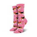 Pair of pink crew socks featuring a repeating pattern of playful beagles and paw prints. 