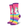 Pair of crew socks; pink background with unicorns and rainbow stripes, white stars.
