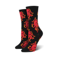 Pair of crew socks with a red octopus pattern on a black background. 