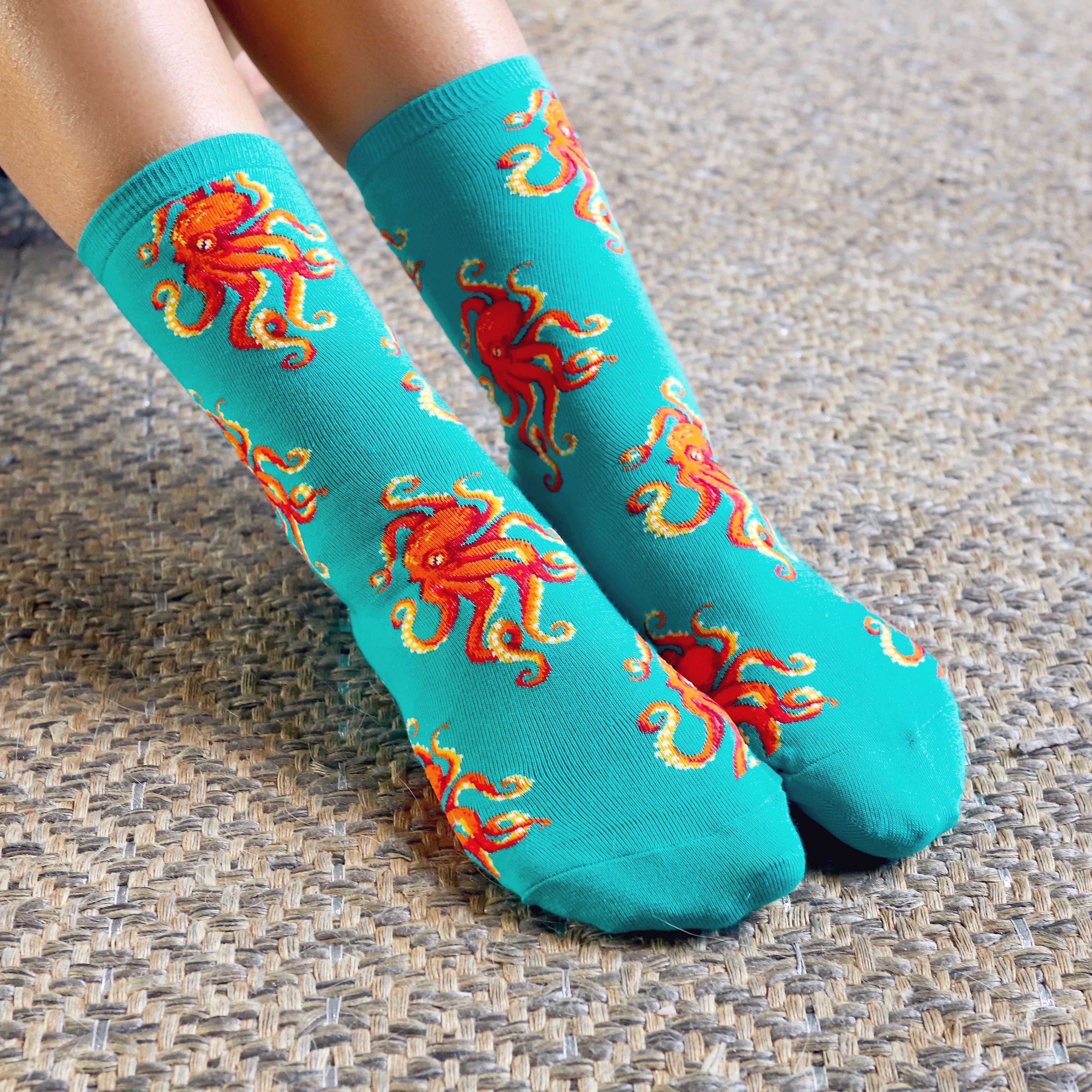 Close-up of teal crew socks with red octopus design. [lf]