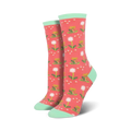 Lifestyle shot showing the coral-colored 'Wishes In The Wind' socks with mint cuffs.