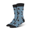 A pair of men's crew socks in blue with a pattern of grey kettlebells and dumbbells.  Black cuffs complete the look.