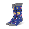 Pair of blue crew socks with a retro arcade design. Features yellow, pink, and white graphics against a blue background, including pixelated spaceships and the words 'Blast Off'.