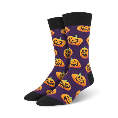 mens purple halloween-themed crew socks feature an all-over pattern of goofy jack-o'-lanterns.  