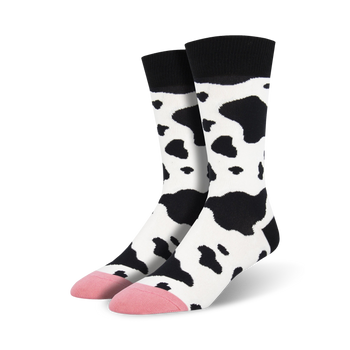 black and white cow print crew socks with pink toes and heels. sock theme is cow.  