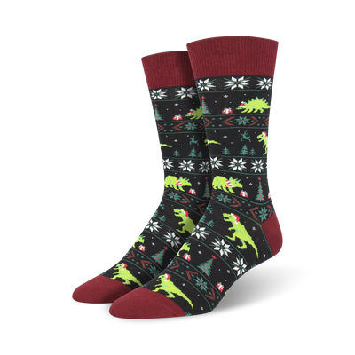 men's santasaurus rex crew socks: black with green dinosaurs wearing santa hats, carrying presents, and red top with white snow flakes   