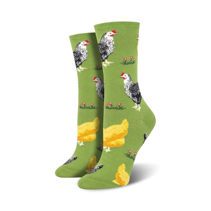 womens bock bock crew socks feature black and white hens and yellow chicks on green grass with red flowers.  