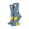 Lifestyle shot of a person's feet wearing the blue chicken socks. They're walking on a light wooden floor.