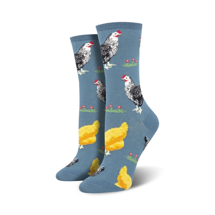 blue crew socks feature a pattern of black and white chickens and yellow chicks on green grass, with red flowers.  