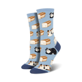A pair of women's crew socks in light blue. The socks feature a pattern of calico and black cats lounging on loaves of bread.