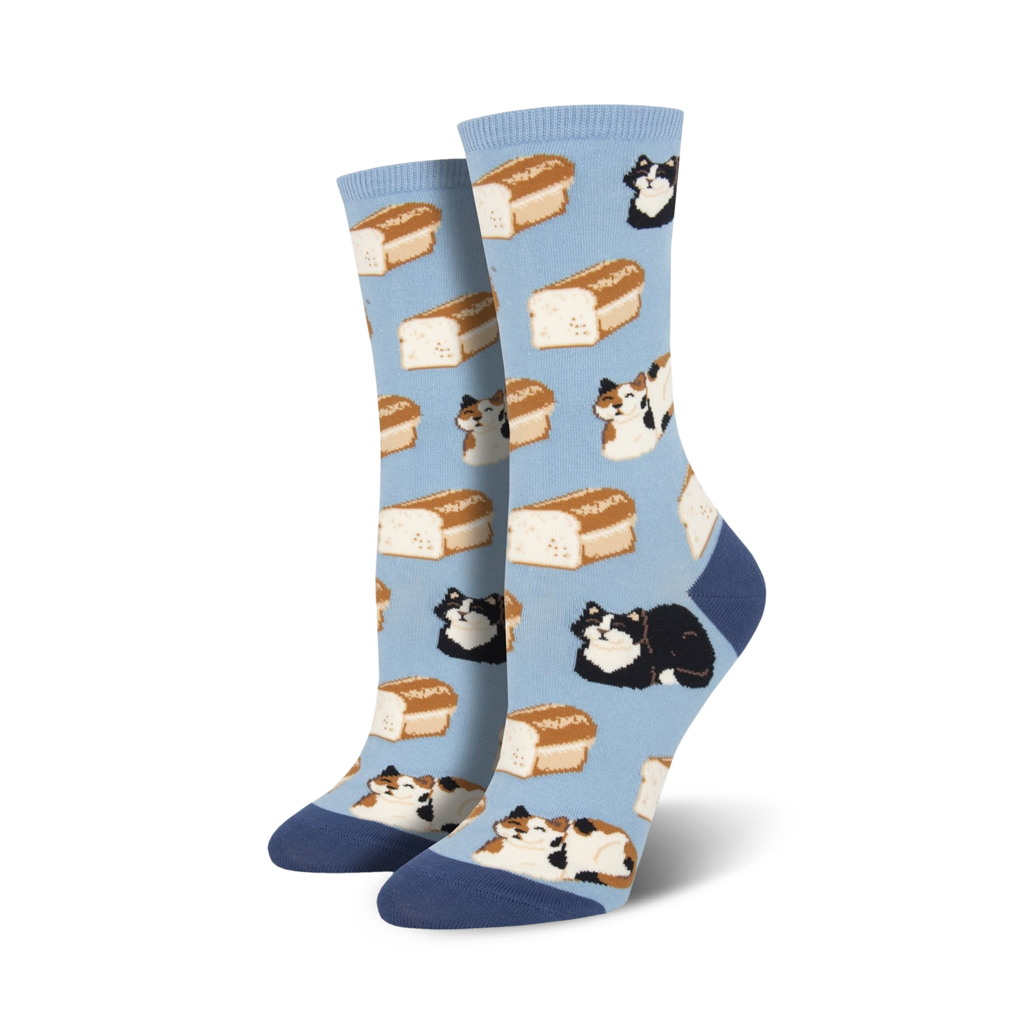 A pair of women's crew socks in light blue. The socks feature a pattern of calico and black cats lounging on loaves of bread.