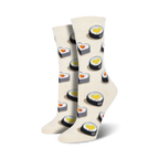 Close-up view of a pair of cream-colored 'Love At First Bite' socks, showcasing the heart-shaped sushi detail.