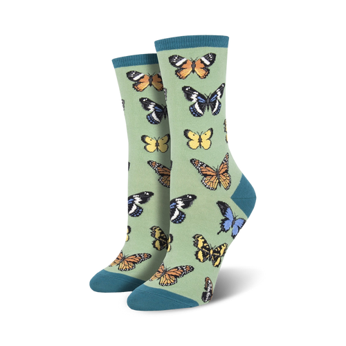 Pair of women's crew socks in sage green with a colorful butterfly pattern. 