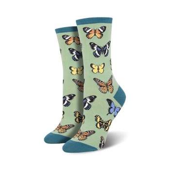 crew socks with an array of butterflies in hues of yellow, orange, blue, and black, set against a serene sage green background
