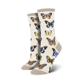 Close-up of women's crew socks in beige featuring a butterfly pattern. 