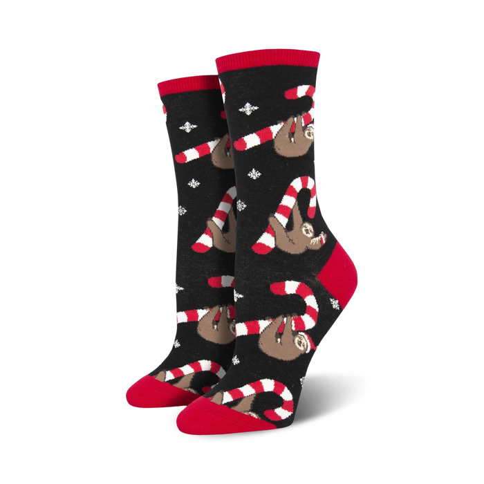 black crew socks feature red and white candy cane pattern with sloths in santa hats. christmas. women's.  