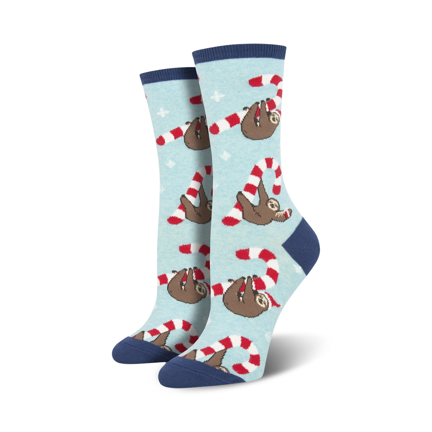 Lifestyle flat lay photo showing a pair of light blue Merry Slothmas socks surrounded by candy canes shaped into hearts.