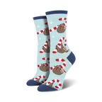 Lifestyle flat lay photo showing a pair of light blue Merry Slothmas socks surrounded by candy canes shaped into hearts.