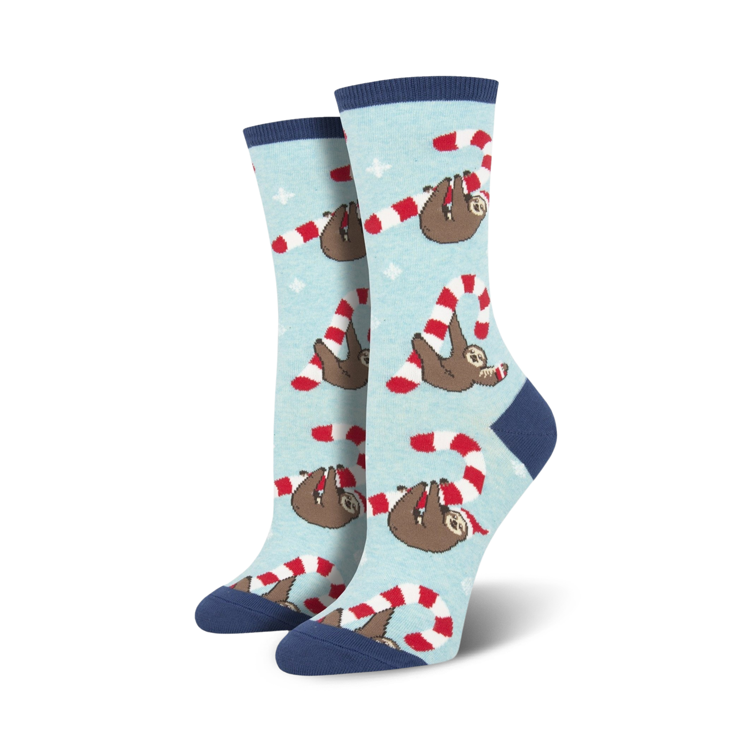 Lifestyle flat lay photo showing a pair of light blue Merry Slothmas socks surrounded by candy canes shaped into hearts.
