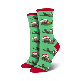 green otters in santa hats swim through a sea of gifts on these festive women's crew socks.   