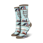 Lifestyle shot of a model's feet wearing the 'Time For A Good Book' socks.