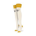 Pair of off-white knee-high socks with mustard yellow cuffs and a small, dark bee graphic on each sock.