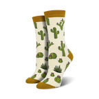 Pair of cream crew socks with a repeating pattern of green cacti and pink flowers. The socks have a mustard yellow cuff.