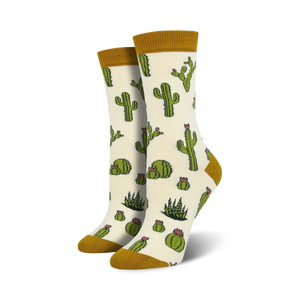 Pair of cream crew socks with a repeating pattern of green cacti and pink flowers. The socks have a mustard yellow cuff.