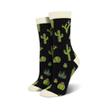 A pair of women's crew socks with a cactus design. The socks are black with green cacti, succulents, and pink flowers.