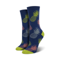 Pair of women's crew socks in navy blue featuring a repeating pattern of pastel pink, green, and grey pineapples.