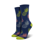 Pair of women's crew socks in navy blue featuring a repeating pattern of pastel pink, green, and grey pineapples.